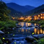 広島の初夏の夜、清流沿いの里山に無数のホタルが舞っている幻想的な風景