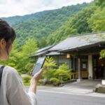広島県世羅町の自然に囲まれた温泉施設をイメージしたブログ用アイキャッチ。手前にスマートフォンで営業状況を確認する旅行者